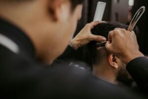 A barber consulting with a client about a hairstyle
