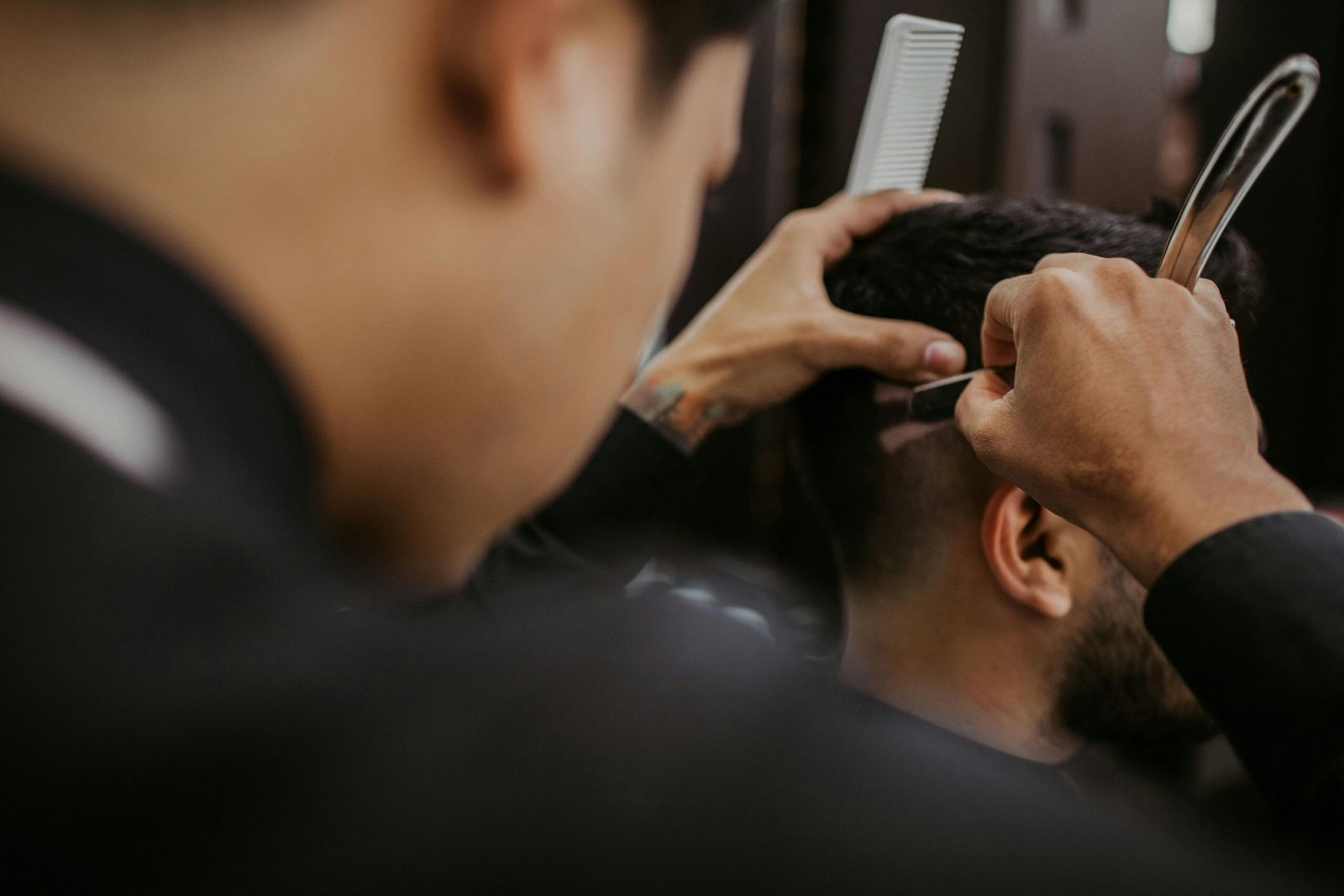 A barber consulting with a client about a hairstyle