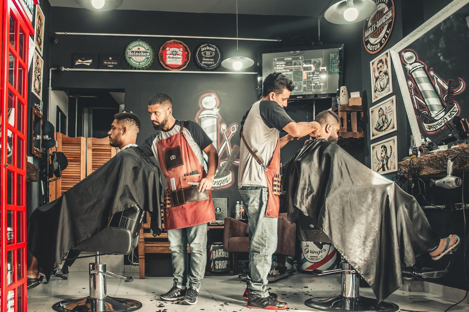 A barber styling a customer's hair using a comb and scissors