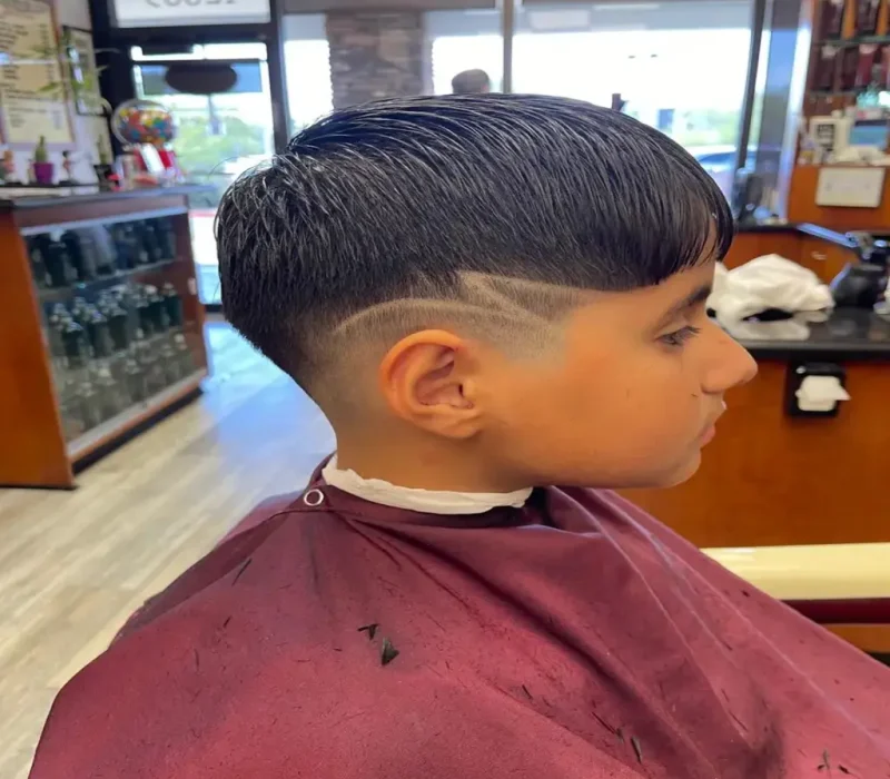 Close-up of a barber giving a precision haircut